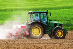 Image of tractor pulling tilling machinery