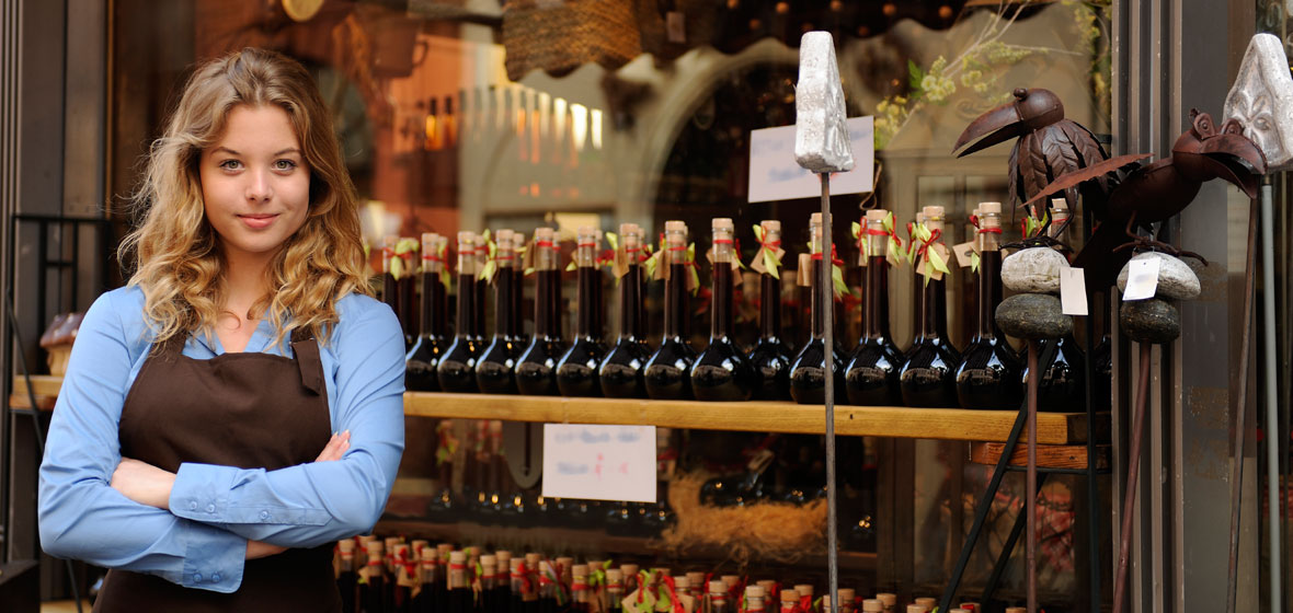 Image of girl standing in front of small business